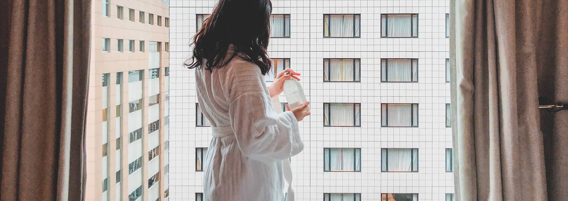 A woman standing near the window